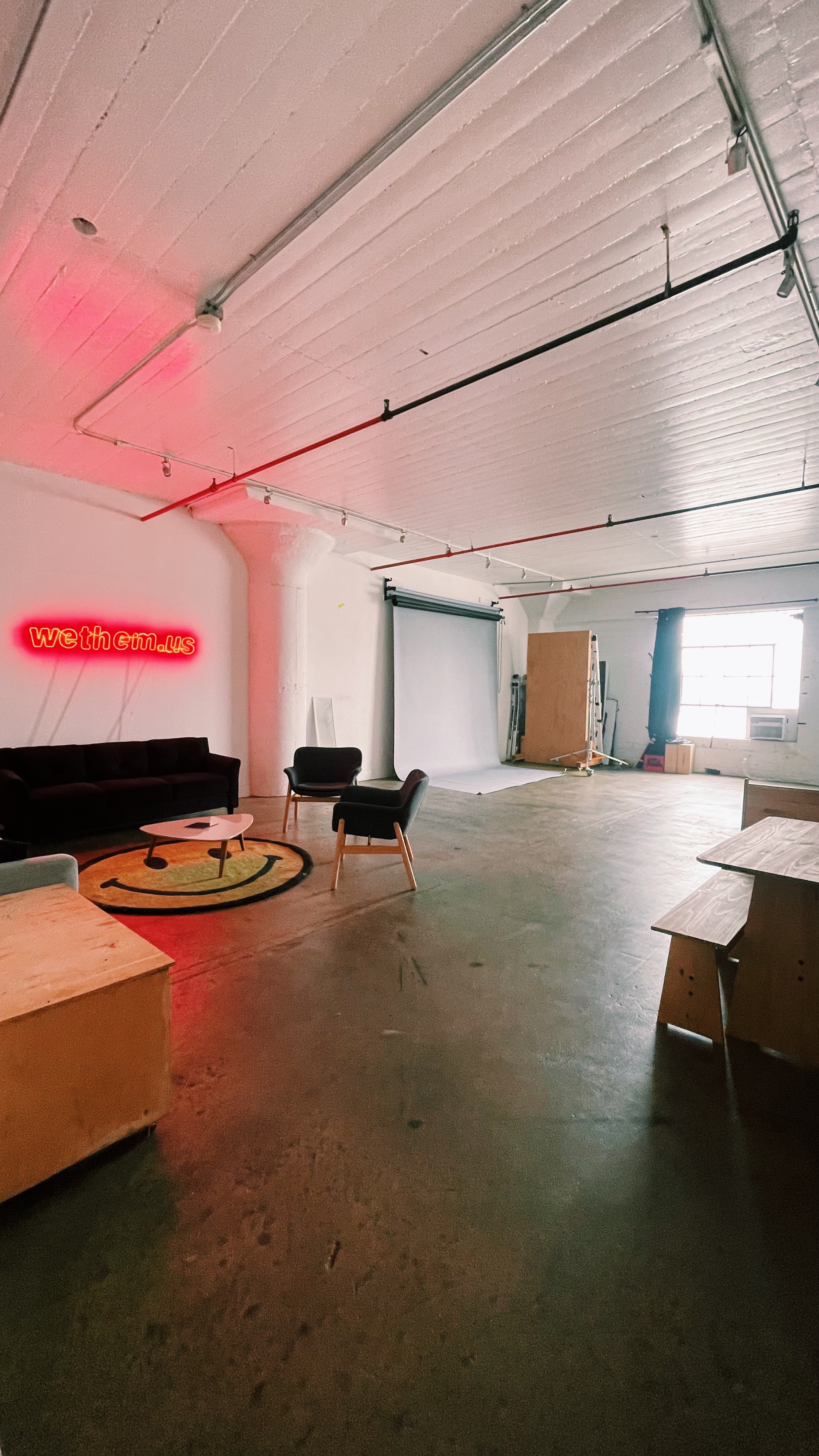 a photo studio with a red neon light on